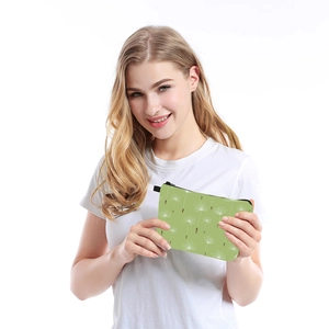 Waterproof toiletry bag with white dandelion print held by a woman in a casual setting