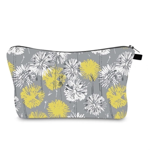 Detail of water-resistant gray makeup bag featuring yellow and white dandelion prints