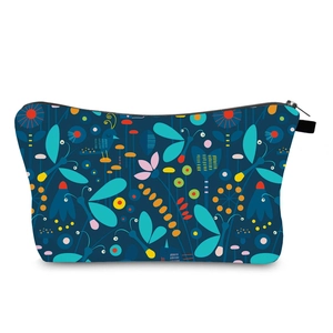 Detail view of water-resistant toiletry bag with colorful dragonfly and floral prints