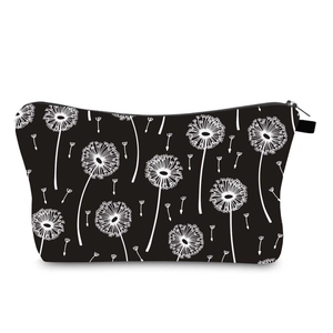 Close-up of waterproof fabric and white dandelion print on black travel makeup bag
