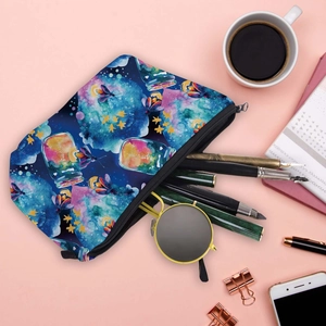 Waterproof travel cosmetic bag with celestial prints and artistic bottles on pink desk