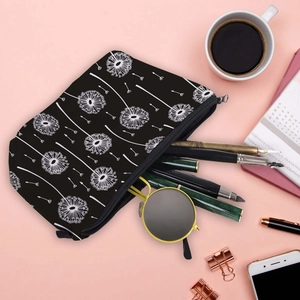 Waterproof travel cosmetic bag with dandelion print, shown with sunglasses and pens
