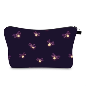 Close-up of waterproof travel makeup bag with glowing firefly print and metal zipper