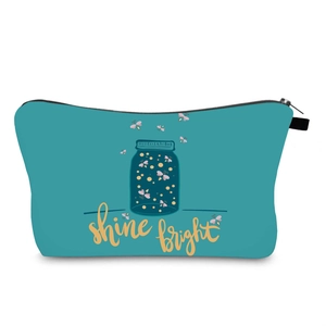 Detail of teal waterproof cosmetic bag with firefly print and shine bright lettering