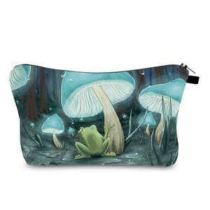 Detailed view of mushroom and frog art print on travel cosmetic bag with black zipper