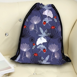 Deep purple drawstring backpack with white floral print and ladybug patterns on a sofa