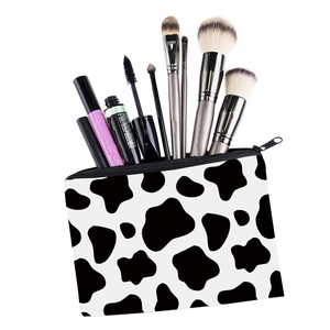 Cow print square makeup bag with black and white spotted fabric and zipper closure