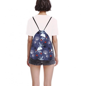 Navy blue drawstring backpack with white flower and ladybug print on a model