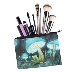 Travel makeup bag with colorful mushroom and frog print filled with cosmetic brushes