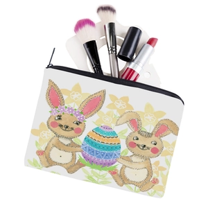 Square rabbit print cosmetic bag with easter egg pattern holding brushes and lipstick