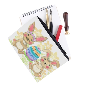 Detail of the rabbit print and smooth black zipper on a white makeup bag