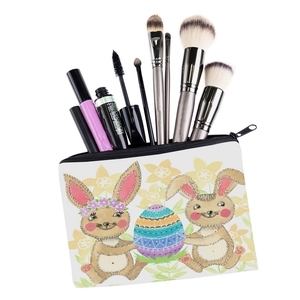 Detail view of rabbit print square makeup bag with zipper and cosmetic tools inside