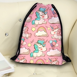 Pink drawstring backpack featuring cartoon unicorn and rainbow prints on a sofa