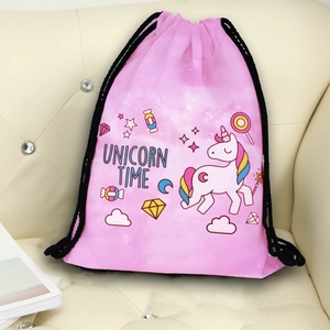 Pink drawstring backpack with unicorn prints and rainbows on a leather sofa