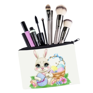 Macro view of portable canvas makeup bag showing rabbit print and interior tool storage