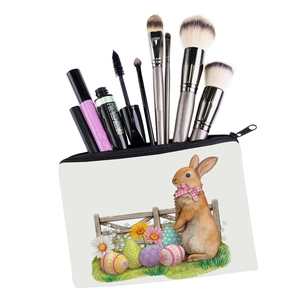 Detail view of the bunny printed makeup bag showing spacious interior and cosmetic brushes
