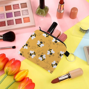 Cute bee print coin purse and portable zipper pouch with lipstick on colorful background
