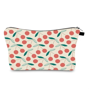 Close-up detail of the water-resistant cherry print makeup bag with a black zipper closure