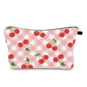 Macro view of water-resistant cherry print makeup bag with pink gingham pattern and zipper
