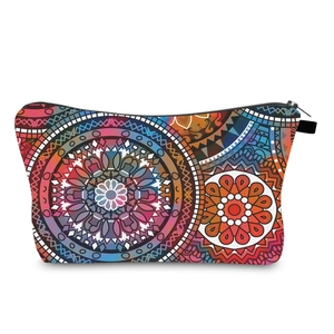 Macro detail of the durable zipper and vibrant mandala pattern on the travel cosmetic bag