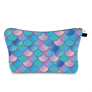 Detailed macro view of trapezoidal makeup bag with vibrant colorful mermaid scale print