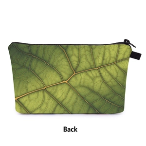 Detailed back view of green leaf print makeup bag showing fabric texture and zipper