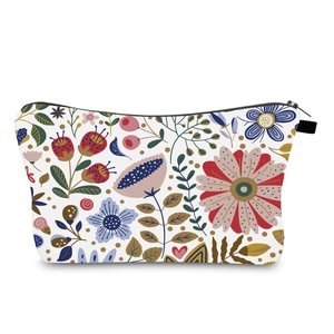 Detail of colorful floral pattern on a cream-colored portable travel cosmetic bag