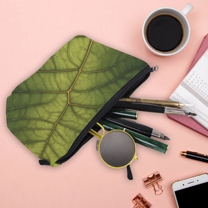Green leaf print toiletry bag with zipper showing storage space for pens and sunglasses