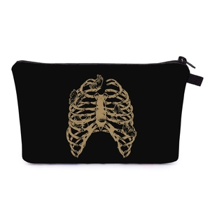 Detail of black makeup bag showing golden gothic butterfly and ribcage print art