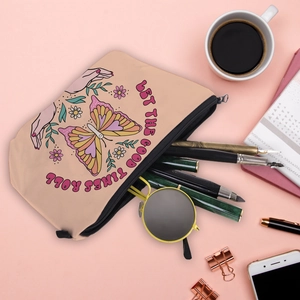 A flat lay macro view of the cute butterfly print travel makeup bag with lifestyle items