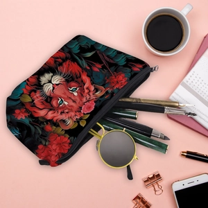 Portable cosmetic bag with tiger print and foliage design on a black canvas surface