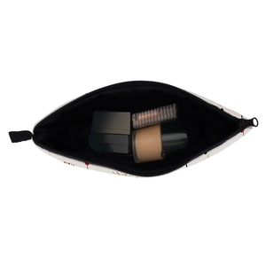 White travel toiletry bag with dandelion print holding foundation and lipstick