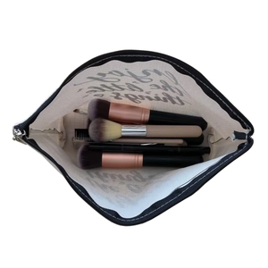 Detailed interior of faux linen makeup bag showing multiple cosmetics brushes inside