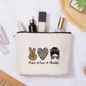 Faux linen makeup bag with Peace Love Momlife print on marble background with skincare