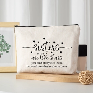 Linen style cosmetic bag for sisters with inspirational text on a wooden stand