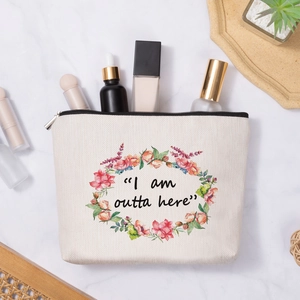 Linen style floral makeup bag with silver zipper on a white marble background
