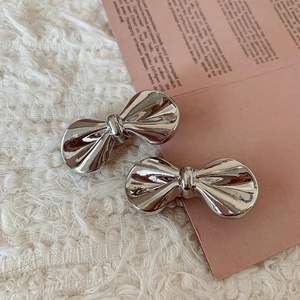 French style metallic silver bow hair clip set on aesthetic fabric background