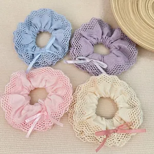 Elegant lace scrunchies in four pastel colors with silk bows for hair styling