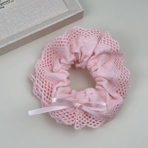 Elegant pink lace scrunchie with silk bow for low bun hairstyles and hair styling