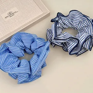 Set of large striped scrunchies in light and dark blue with pleated ruffled edge