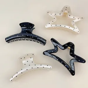 Set of four French chic polka dot star and curved hair claws in black and white colors
