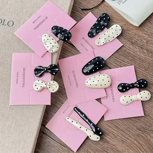 French style black and white polka dot hair clip set on a decorative pink card