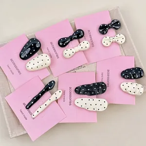 French chic black and white polka dot metal hair clips set on pink display card