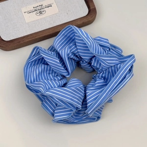 Blue and white striped scrunchie fabric hair tie with elegant pleated design for women