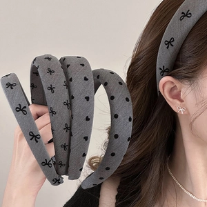 Gray fabric bow headband for women featuring small black heart and polka dot patterns