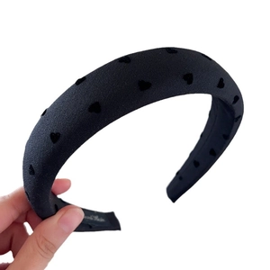 Padded black sponge headband with flocked heart pattern for a stylish high skull top look