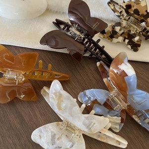 Elegant butterfly hair claw clip made of tortoiseshell acetate with handmade gold lettering