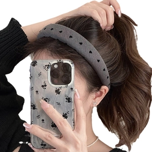 Gray bow headband with black heart pattern for a high cranial top hairstyle look