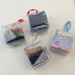 Elastic bow hair ties in assorted colors within transparent gift boxes for daily styling