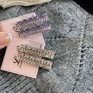 Sparkling purple and champagne rectangle crystal duckbill hair clips on pink card